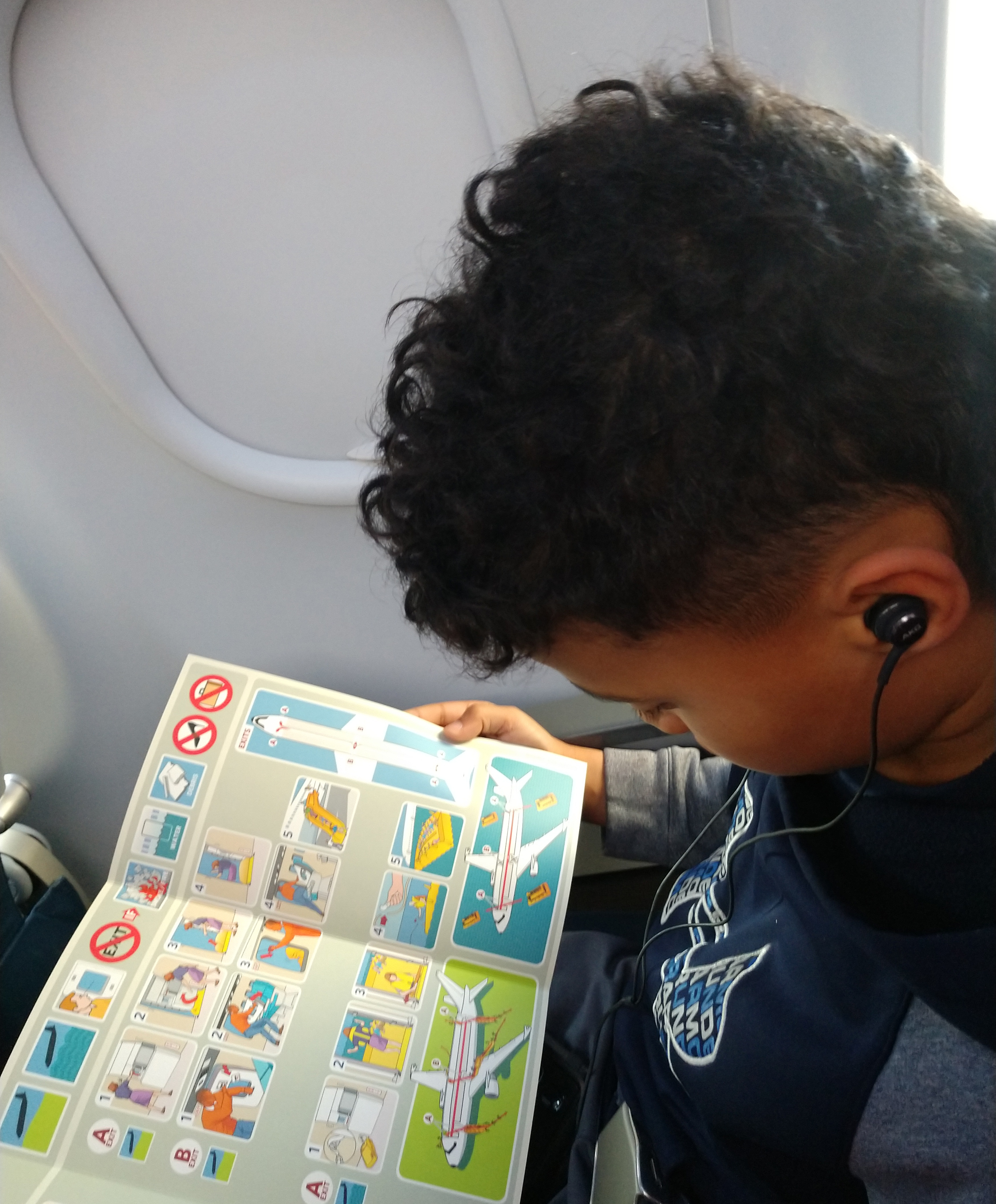 Ruell reading airplane safety brochure